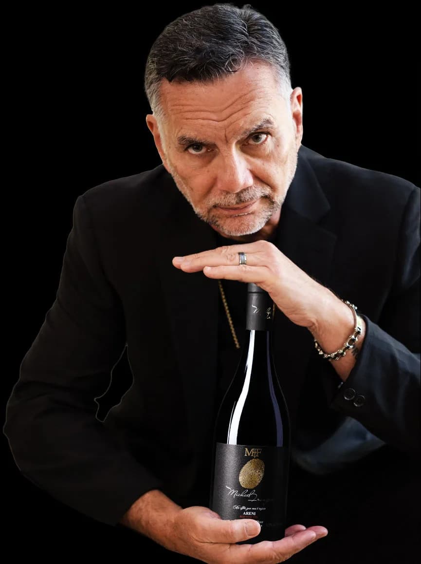 Michael Franzese holding a bottle of Areni